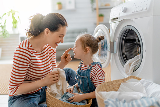 Mother and daughter in laundry room.