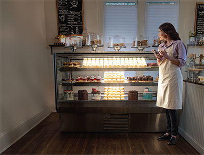 Bakery case with baked goods lit up in a T shape.