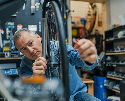 man fixing a bicycle