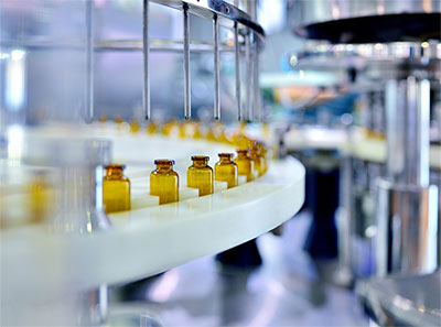 Bottles being filled in a manufacturing line.
