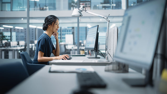Woman sitting at a desk working on a computer