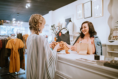 A saleswoman and her customer making a sale in a boutique.