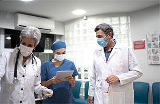 Three doctors reviewing a patient file