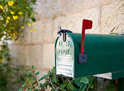 Green mailbox with the signal flag up.