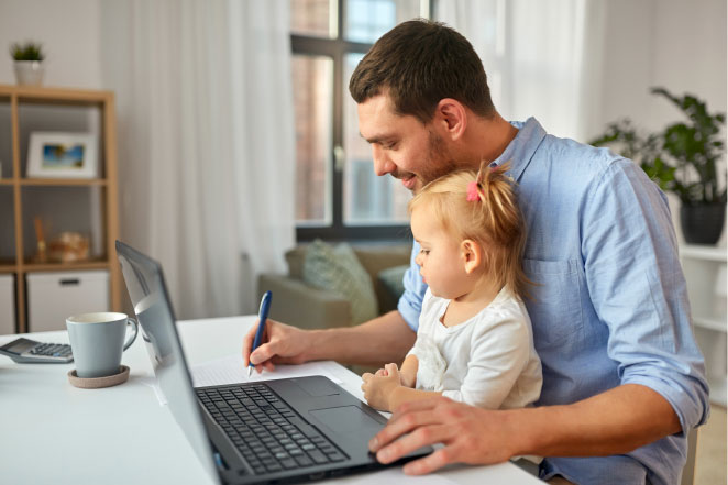 Father and his child working at a computer.