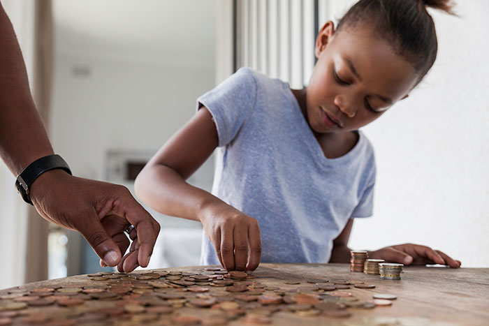 Young girl counting coins.