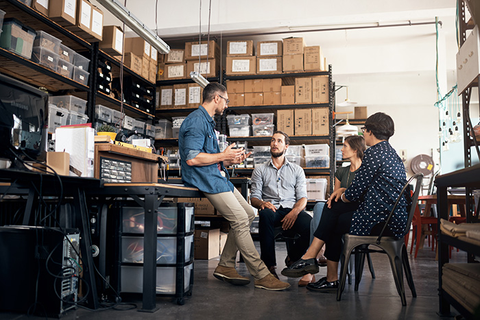 colleagues meeting in a warehouse
