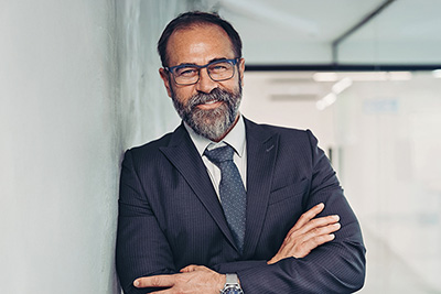 Executive leaning against a wall