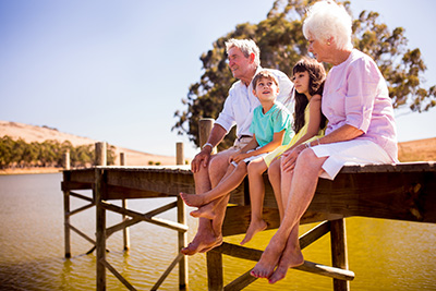 grandparents and grandkids sitting on a dock