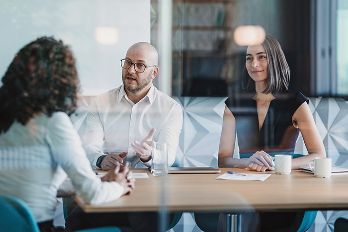three people having a discussion