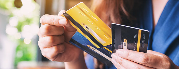 Close-up of woman holding 3 credit cards.